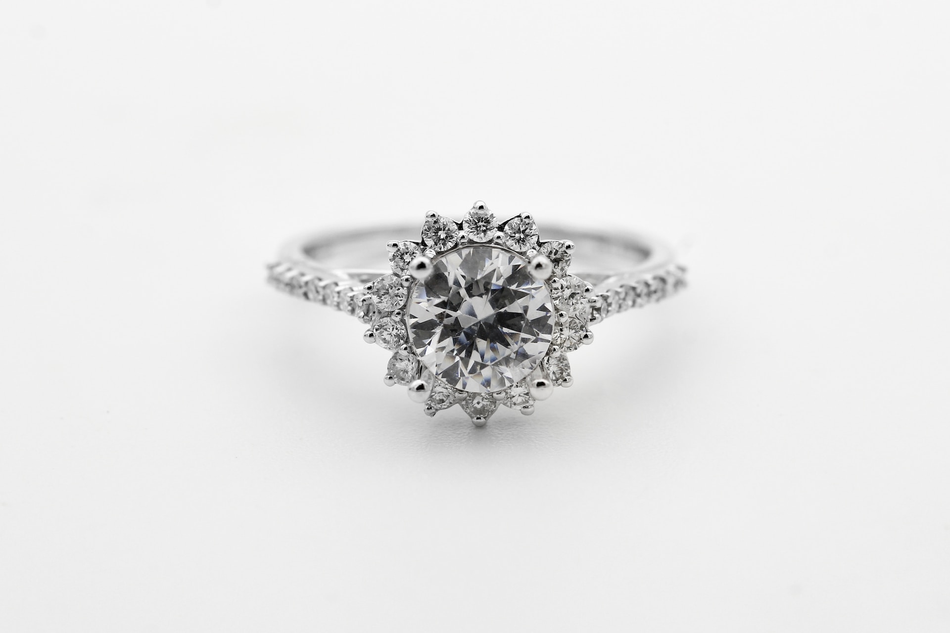 a round cut halo engagement ring on a gray background