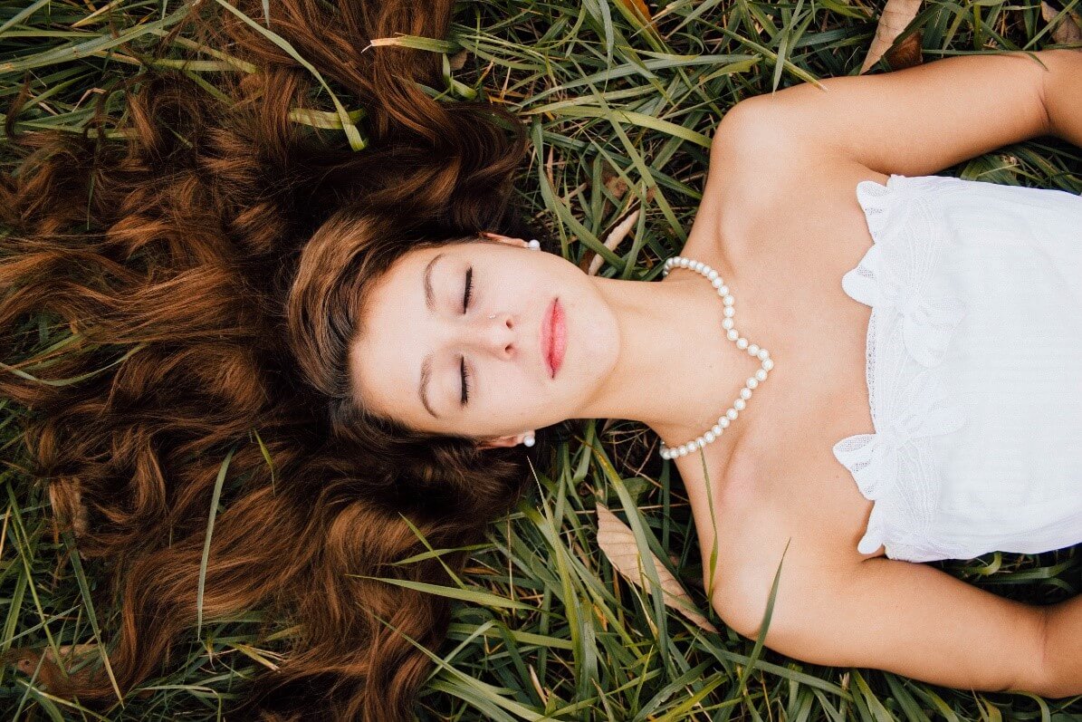 Girl with pearls on the grass