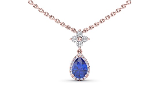 a rose gold pendant necklace featuring a sapphire and diamonds