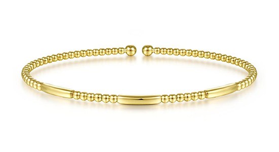 a yellow gold bangle bracelet by Gabriel & Co.