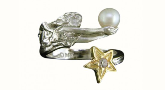 a sterling silver fashion ring featuring a yellow gold star, an angel, and a pearl
