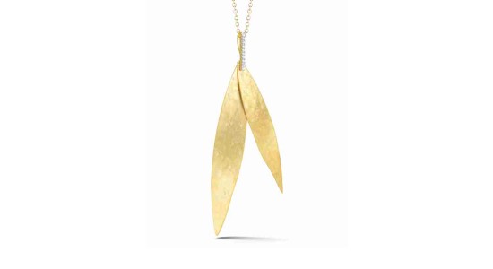 a yellow gold pendant necklace featuring two leaf-like pendants