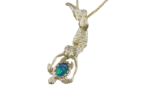 A close-up of an elegant pendant necklace intricately sculpted in the form of a mermaid holding a sea turtle with an opal adorning the shell, available at Long Jewelers.