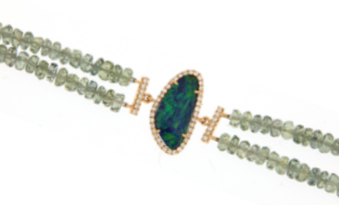 An elegant opal bracelet adorned with beads and diamond details, available at Long Jewelers.