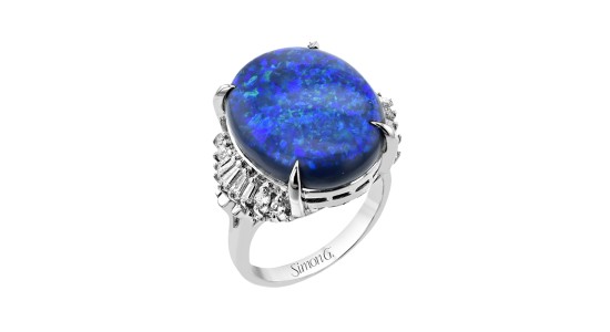 a platinum statement ring featuring a large blue opal and accent diamonds