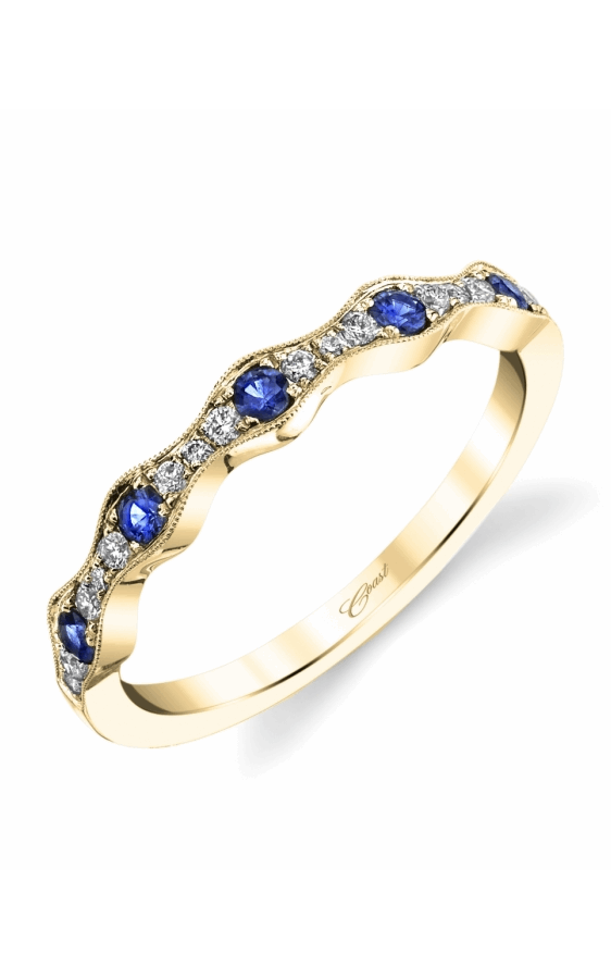 A yellow gold fashion ring with round diamond and sapphires on a white background