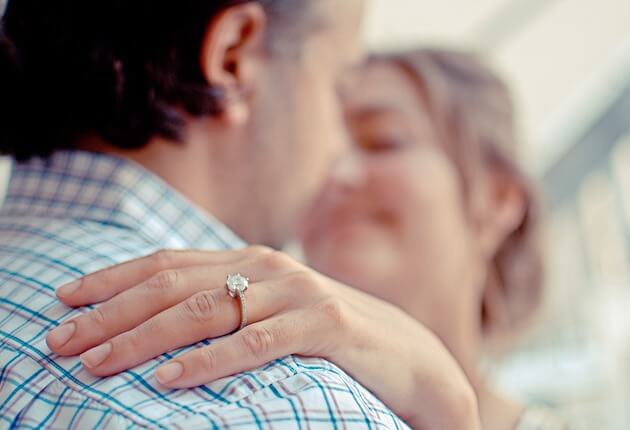 Couple Holding with Princess Cut Ring