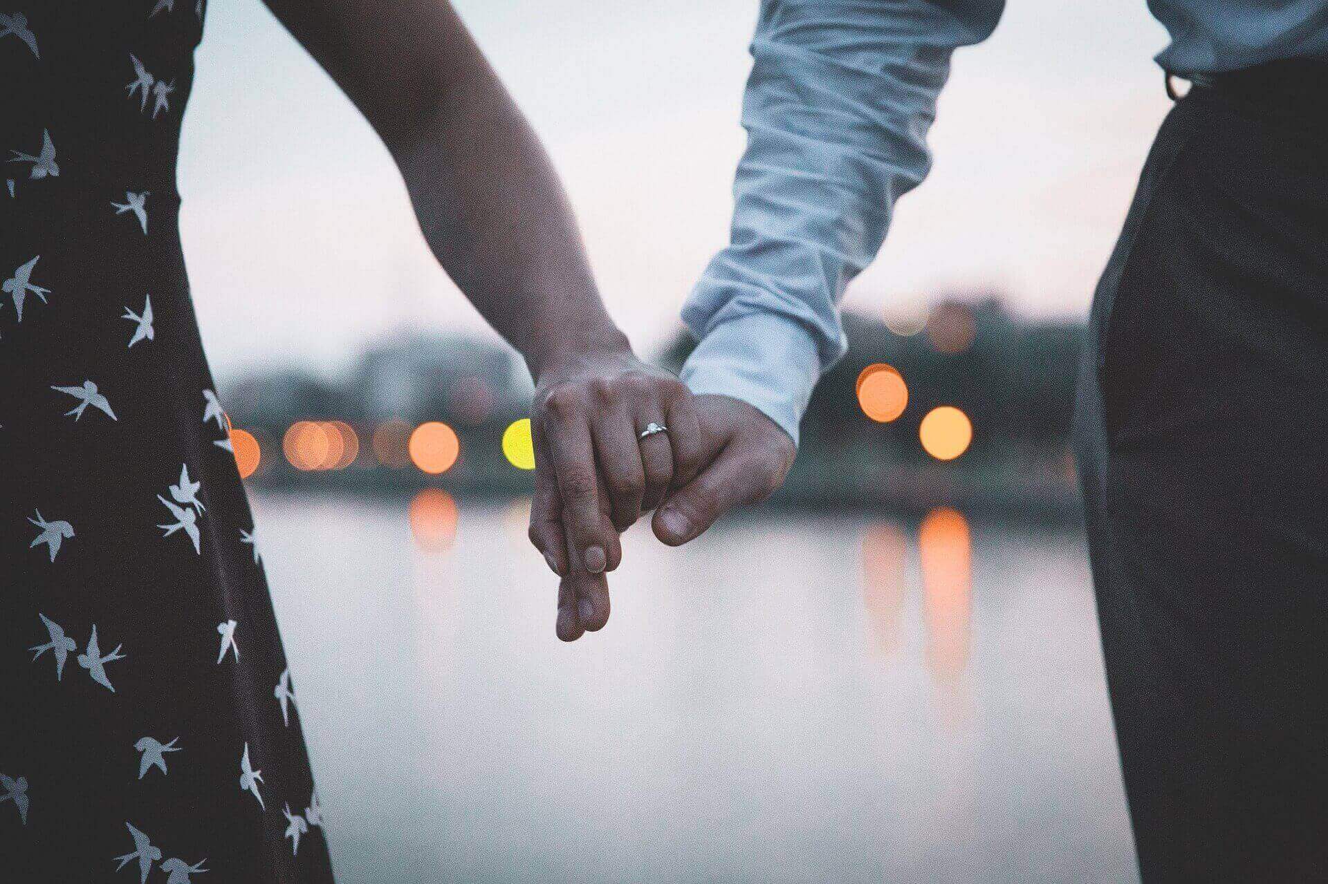 Couple on a Dock Holding Hands