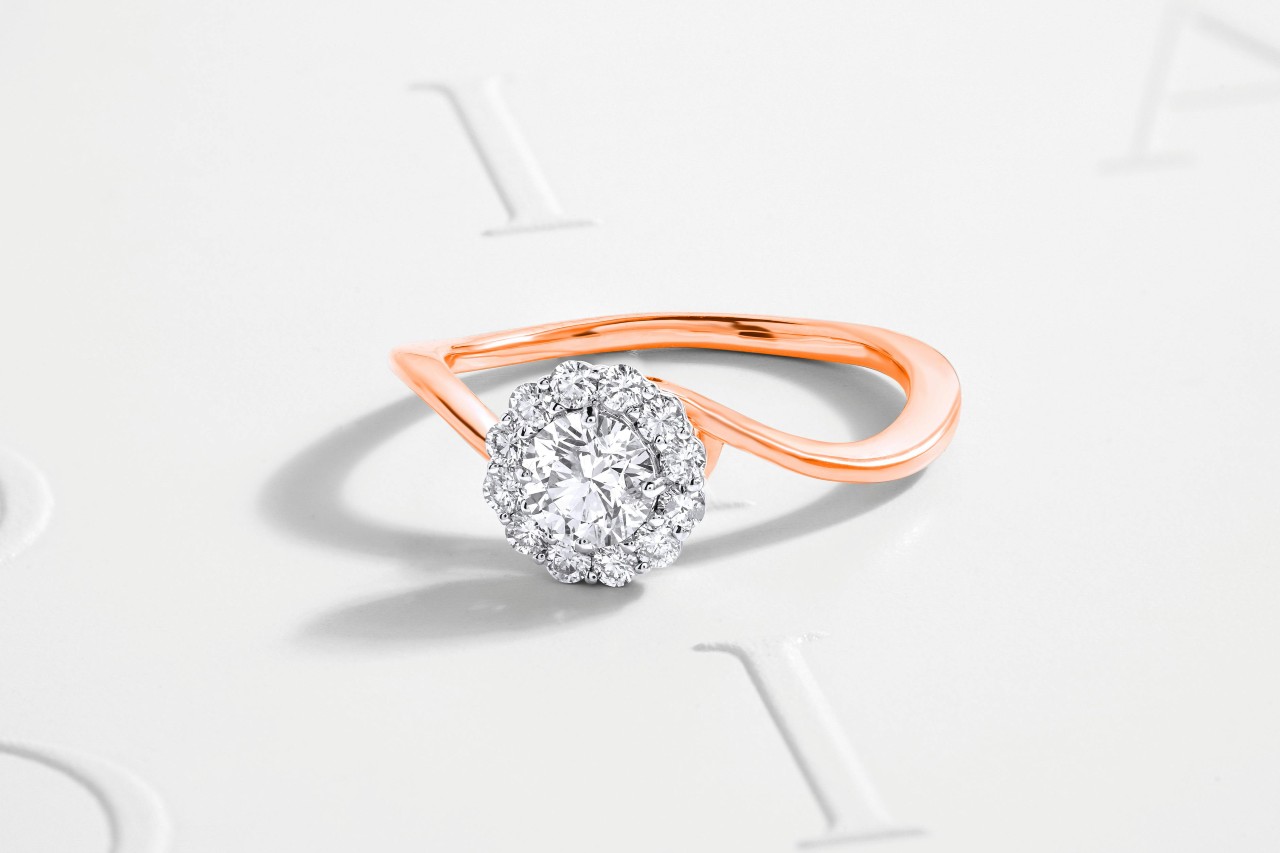 a mixed metal engagement ring with a halo set center stone a mixed metal engagement ring with a halo set center stone