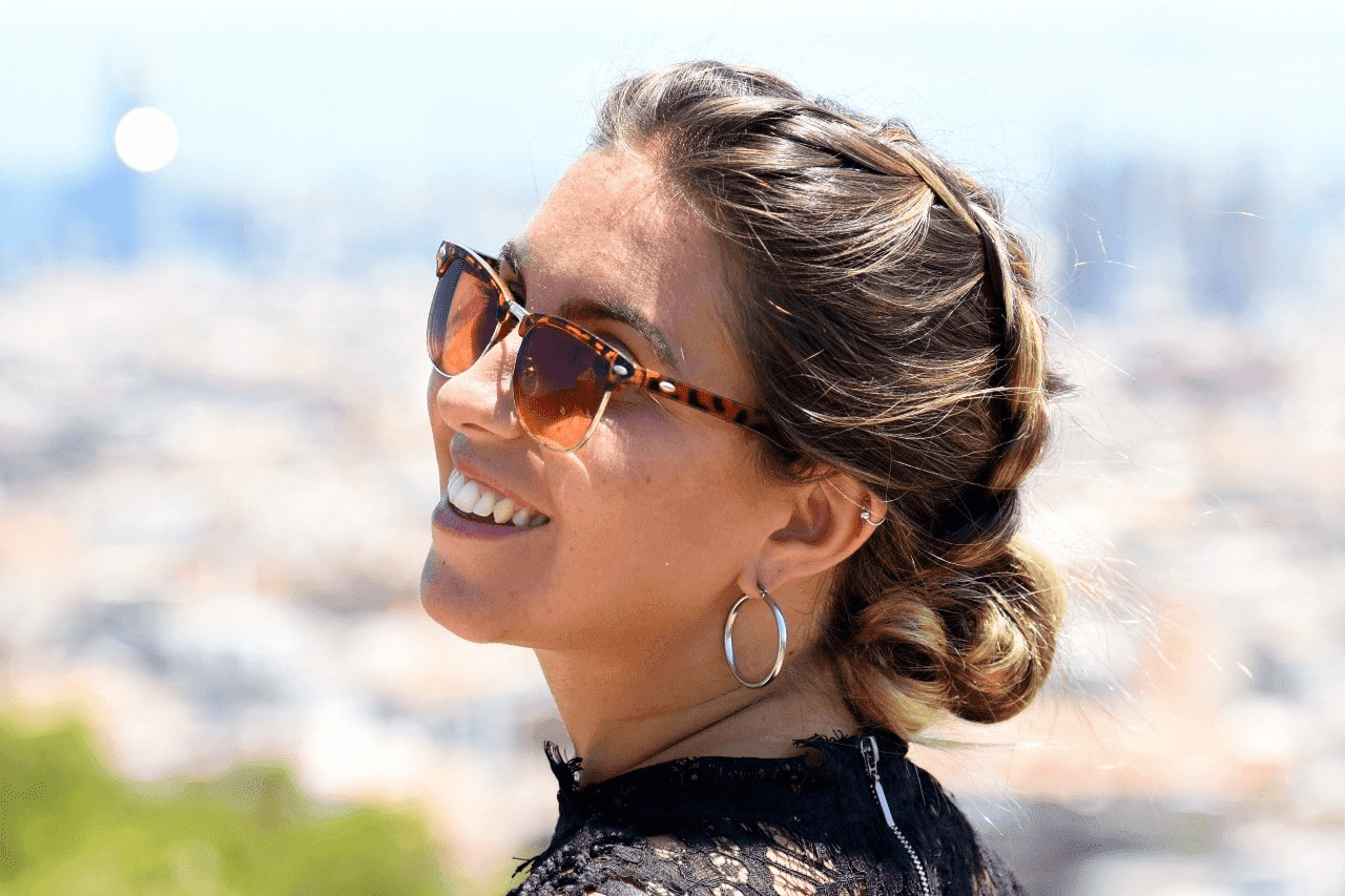 woman smiling and wearing white gold earrings