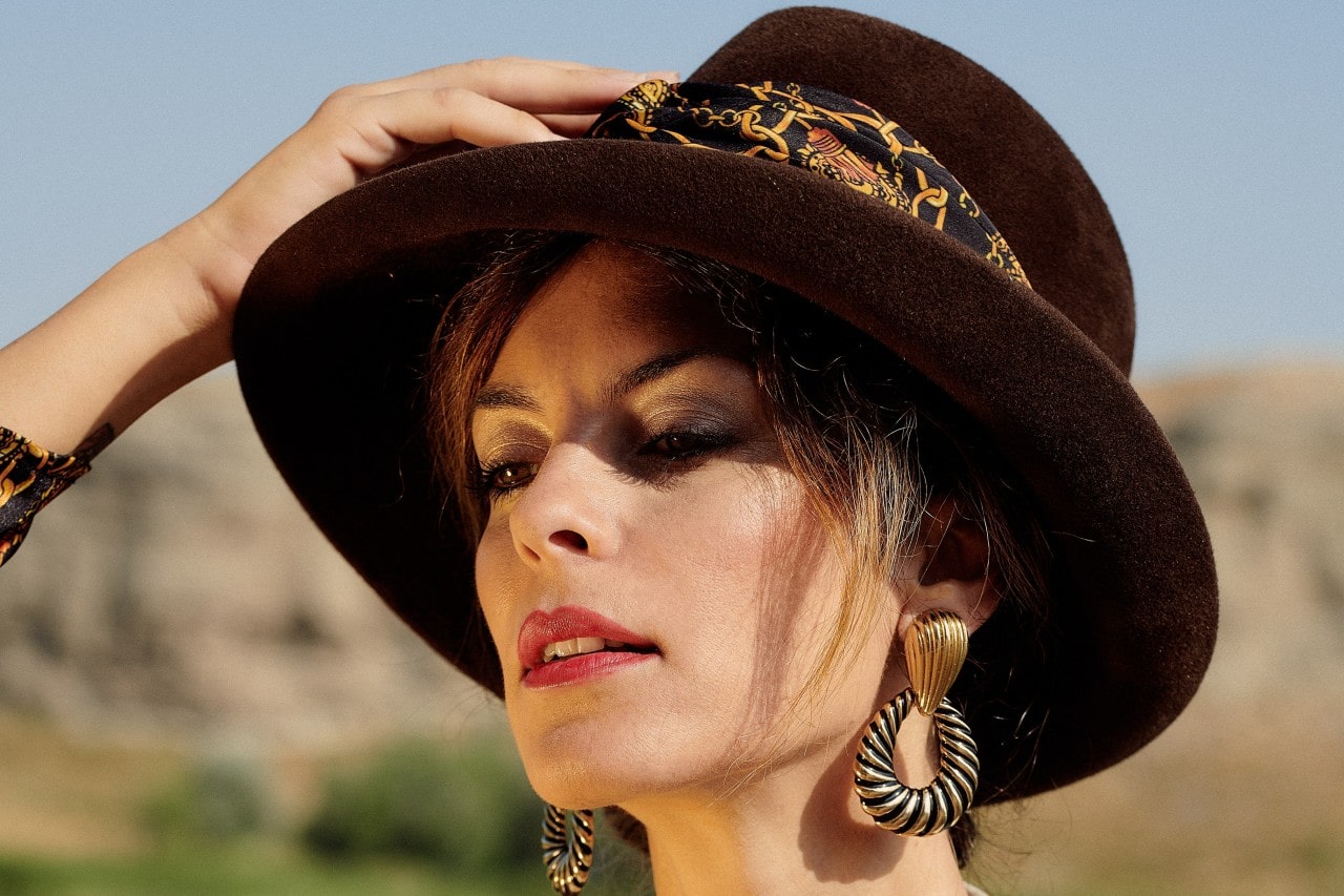 A close-up of a fashionable woman wearing distinctive earrings. A close-up of a fashionable woman wearing distinctive earrings.