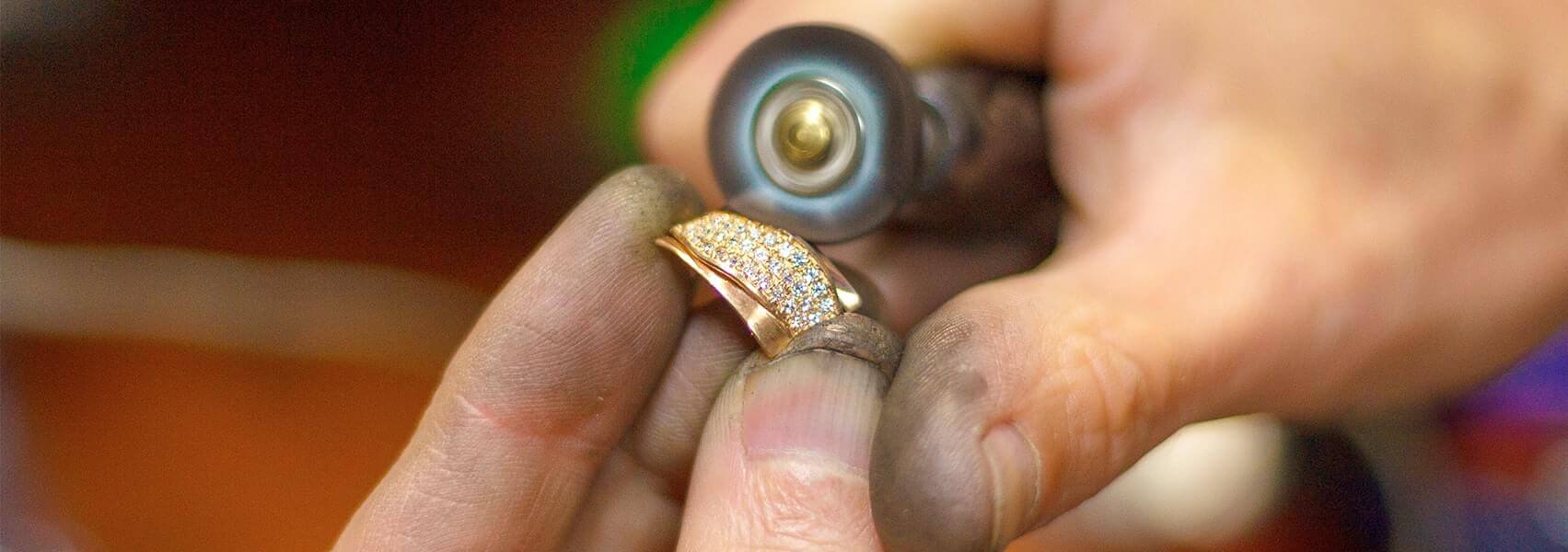 repairing jewelery at a workbench repairing jewelery at a workbench